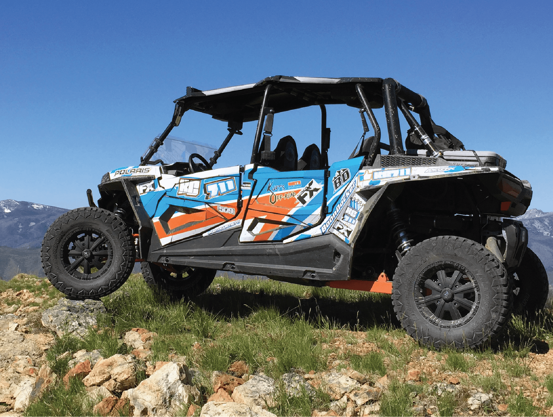 Polaris side by side parked offroad at the top of a mountain.